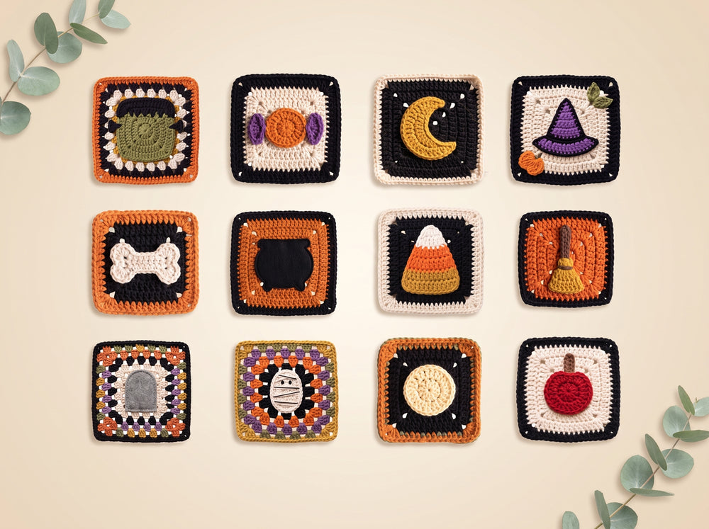 A set of 12 handmade crocheted square coasters arranged in a 3x4 grid on a light beige background with decorative eucalyptus leaves in the corners. Each coaster features a different Halloween-themed design, including a tombstone, candy corn, moon, witch hat, broom, cat, pumpkin, and other spooky motifs.