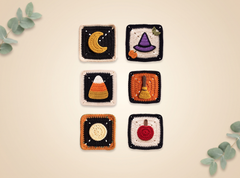 Six handmade crocheted square coasters with Halloween-themed designs, arranged in a 2x3 grid on a light beige background with decorative eucalyptus leaves in the corners.